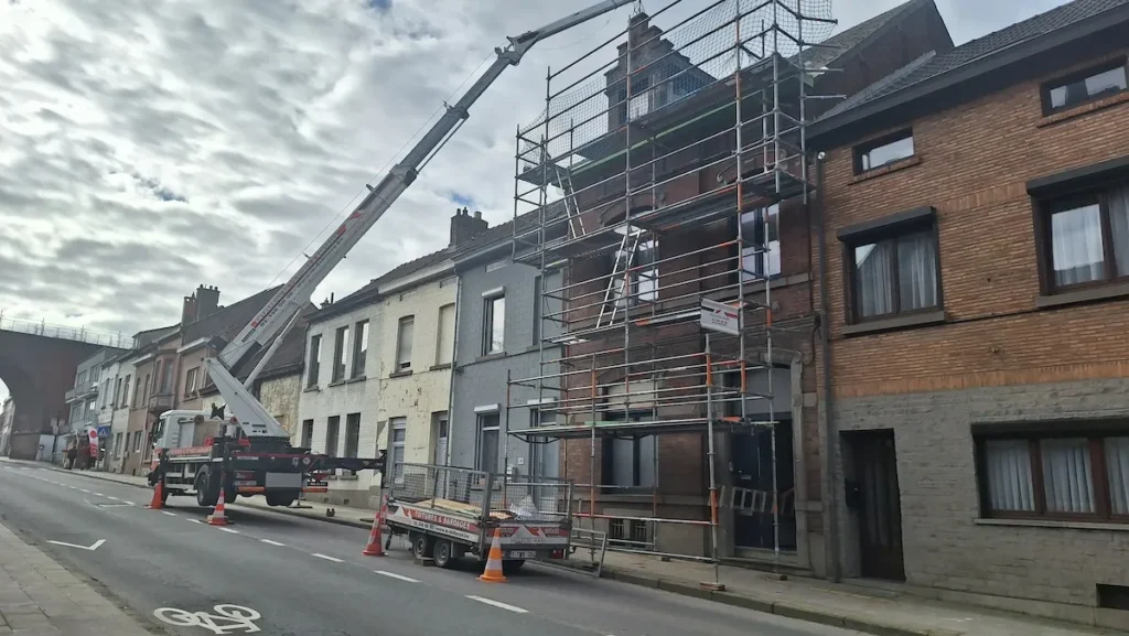 Echafaudage devant une maison de rangée dont la toiture est en travaux